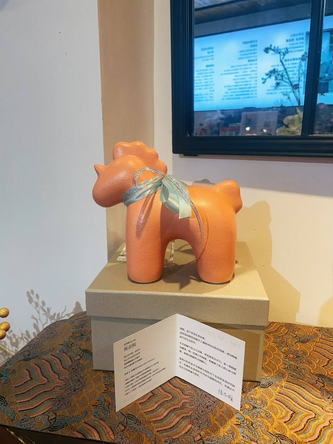 Orange porcelain Unicorn-Orange figurine with ribbon bow displayed on box