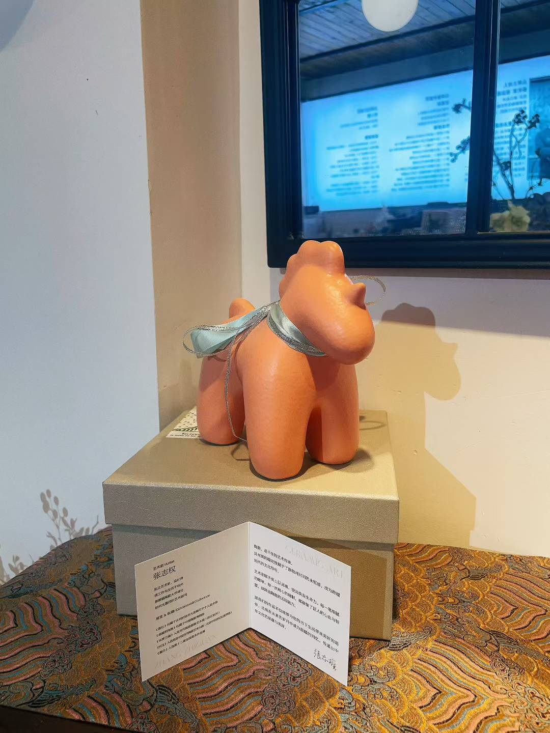 Orange porcelain Unicorn-Orange figurine with blue ribbon, size 19x10x17cm displayed on box